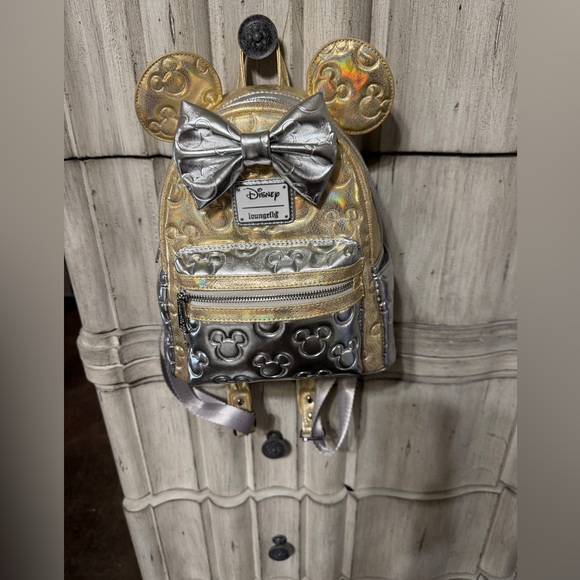 Loungefly Handbags - Loungefly Disney Gold and Silver Bow Mini Backpack